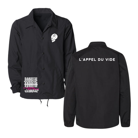 The Sadistik black nylon jacket features a white skull graphic on the front left chest, white and pink text on the lower front, "LAPPEL DU VIDE" in bold white letters across the upper back, and a water-resistant windbreaker design for protection.