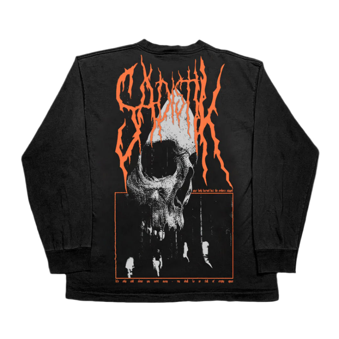 A black Sadistik long sleeve features a large menacing skull graphic on the back with jagged orange text and a dark, eerie scene with silhouettes beneath the skull.