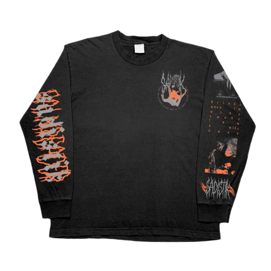 A black Sadistik Gildan Heavy Cotton long sleeve shirt with orange and gray graphics, stylized sleeve text, and a circular chest design featuring a red hand and white text. Made from 100% cotton for lasting comfort.