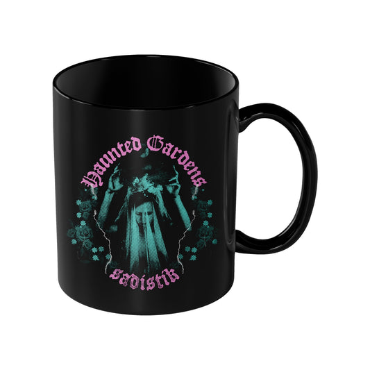 Sadistik Haunted Mug: Black mug with a teal and white ghostly figure and flowers, pink Gothic Haunted Garden above, and white Gothic SVOISIT below.
